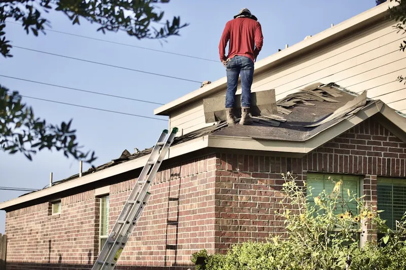 Professional roofer working on a residential roof in Newport News